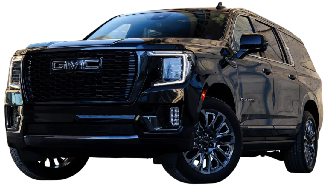 A 2025 GMC Yukon parked outside a building, promoting airport pickups and family travel with premium comfort in Chicago.